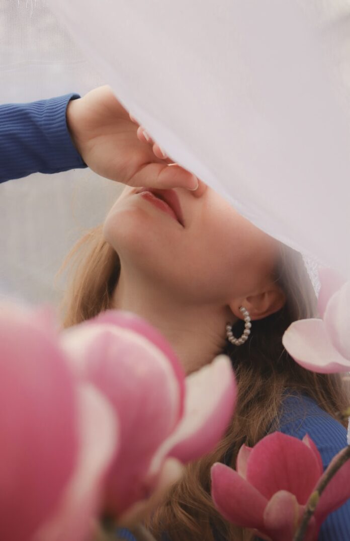 Photo by Adéla Monczková a woman with her eyes closed and her hand on her head