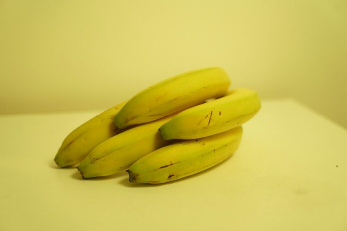 Photo by Radu Prodan a bunch of bananas sitting on top of a table
